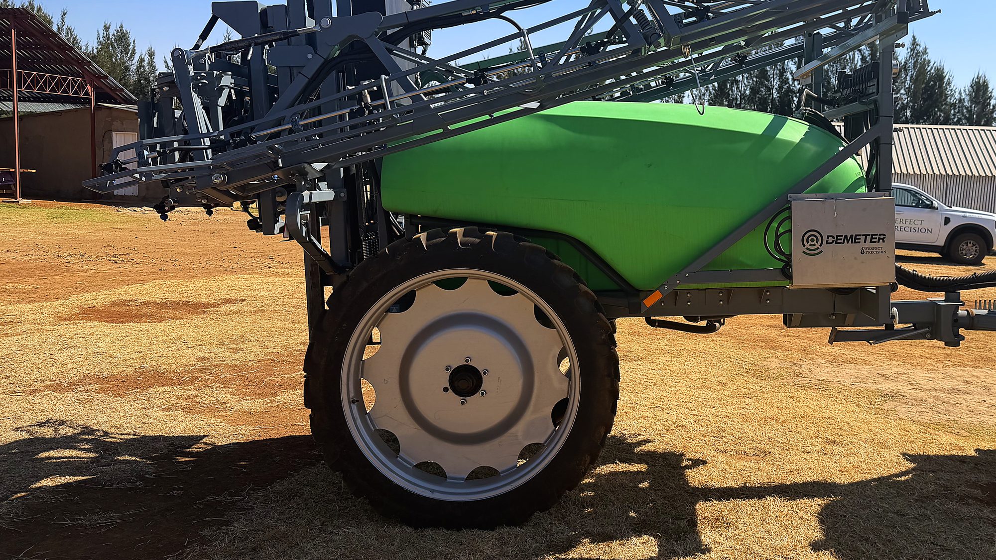 The Demeter 2000L trailed sprayer, boom folded, in the yard