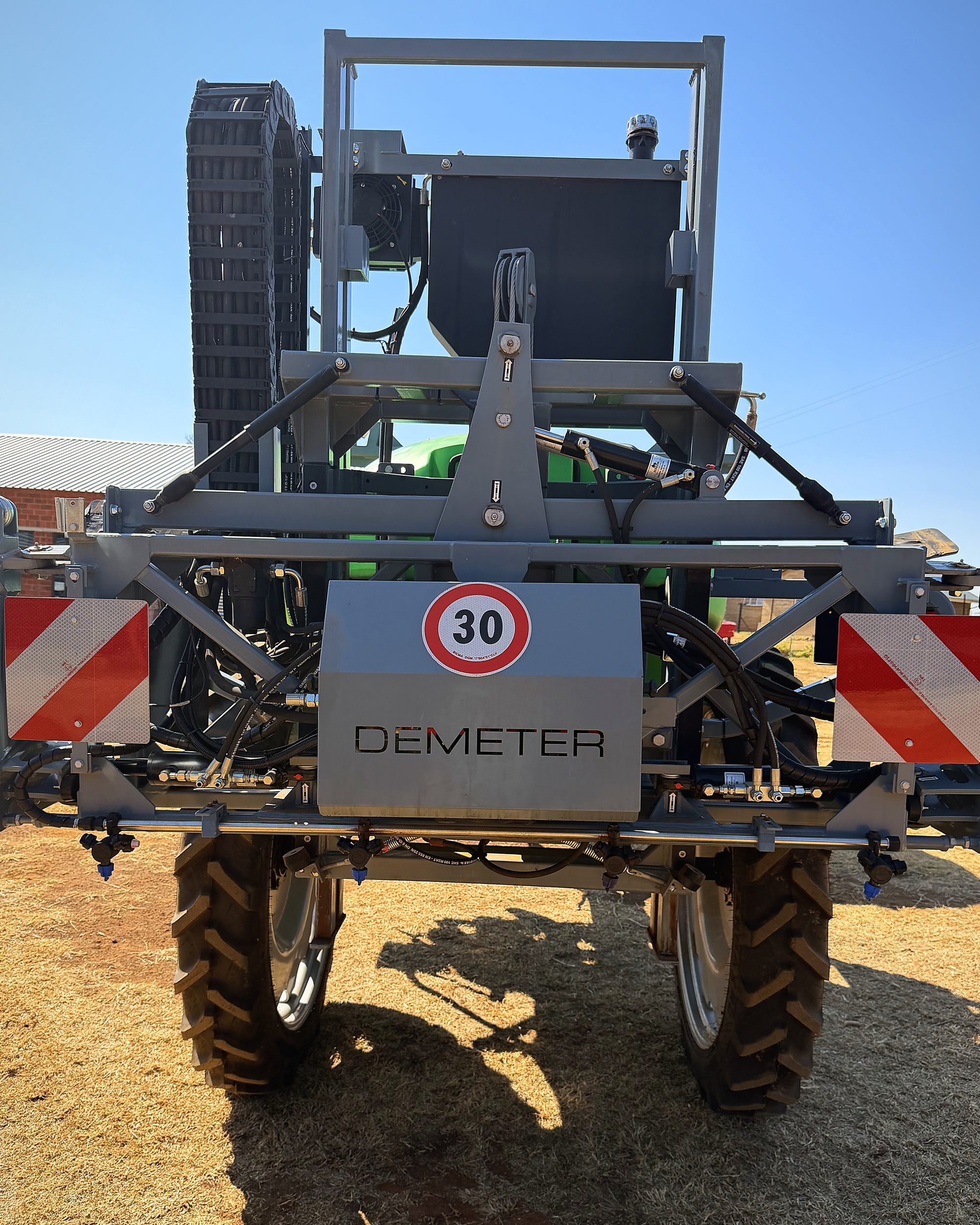 The rear of the Demeter sprayer with its badge and lights