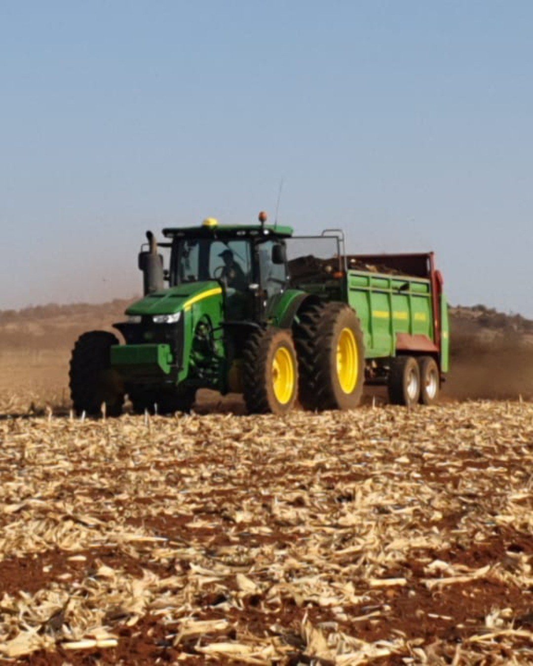 A tractor and spreader working a land