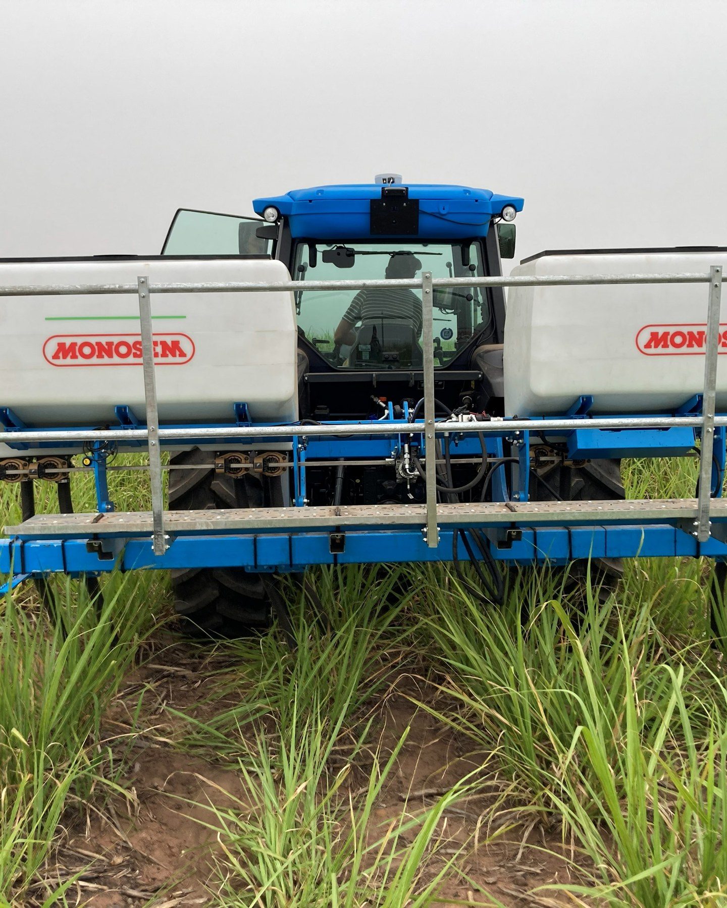 A planter working after dark under its work lights